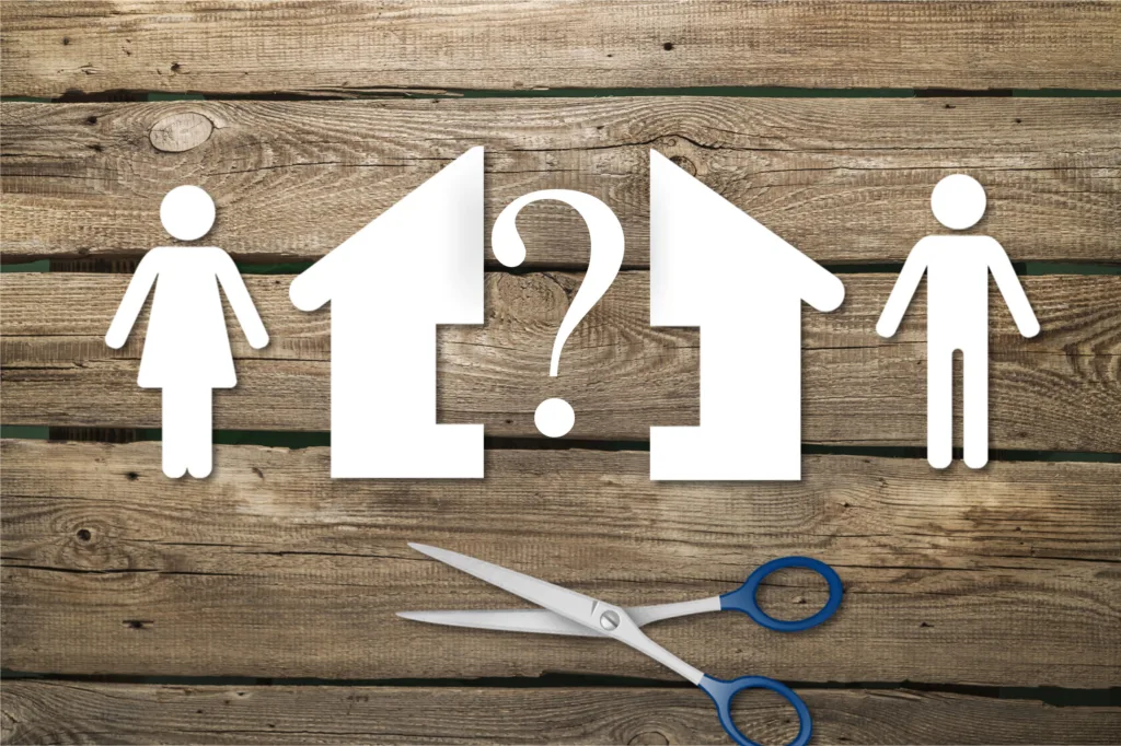 Icons of two people and two houses separated by a question mark, showing home decisions during divorce.