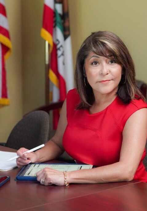 Photo of Certified Divorce Lending Professional, Amy Valdivia, at her desk ready to help with divorce planning.